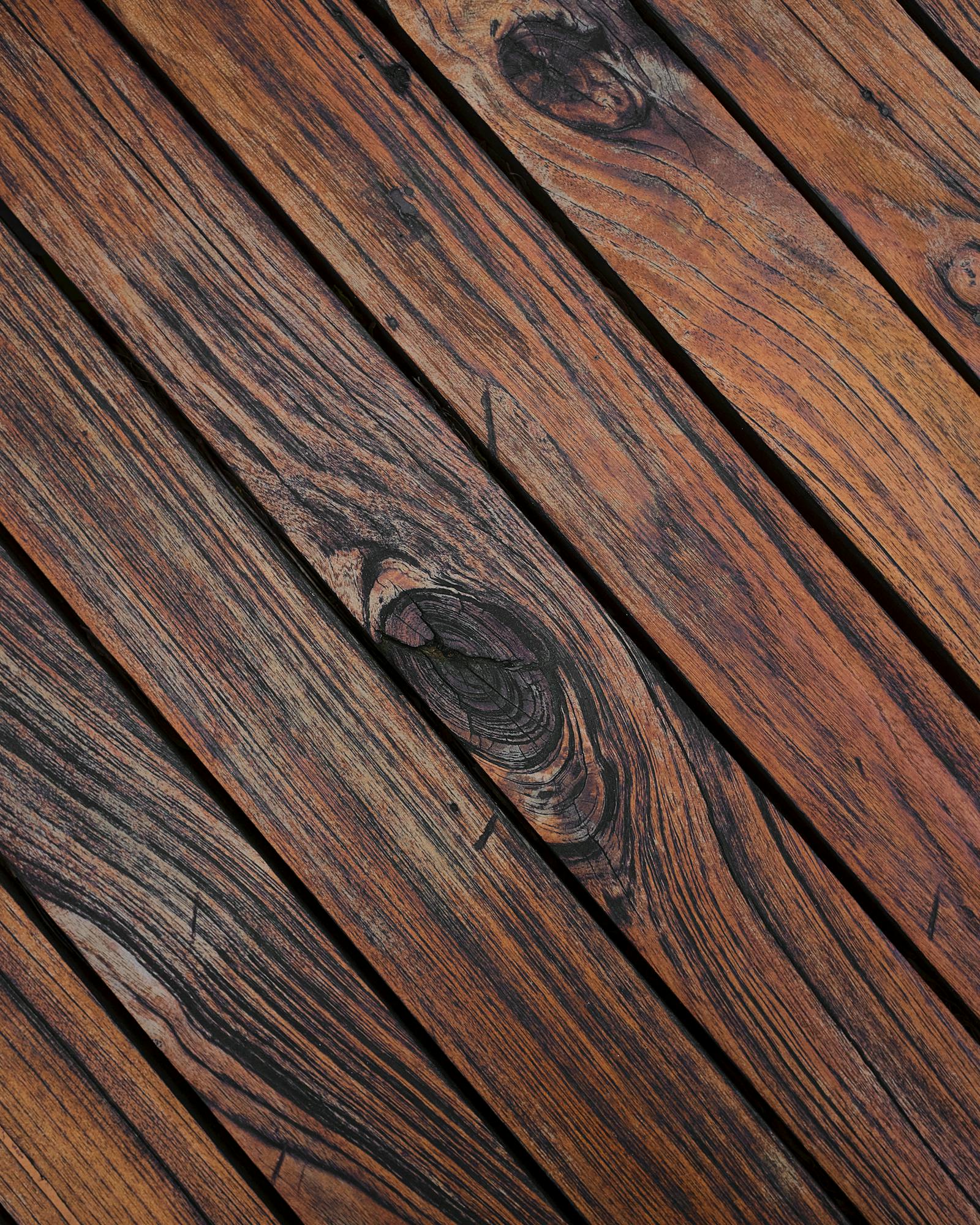 Weathered gray wood deck planks before cleaning and restoration