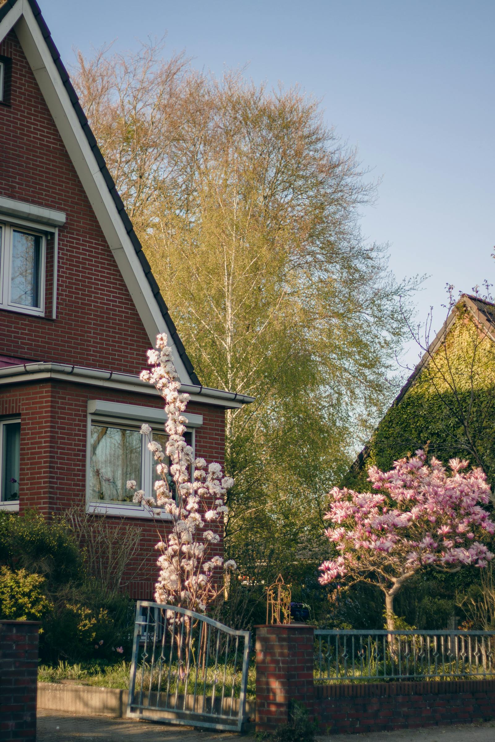Brick Bethesda home with vibrant spring garden and blooming trees